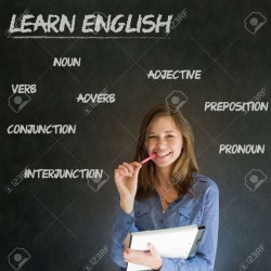 19049076-Learn-English-confident-beautiful-woman-teacher-chalk-blackboard-background-Stock-Photo